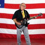 Craig Bell in front of an American flag.
